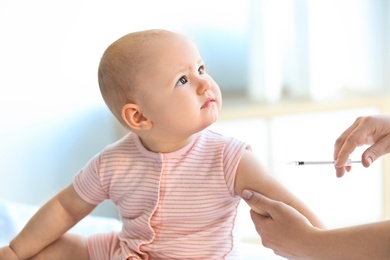 Doctor vaccinating baby in clinic