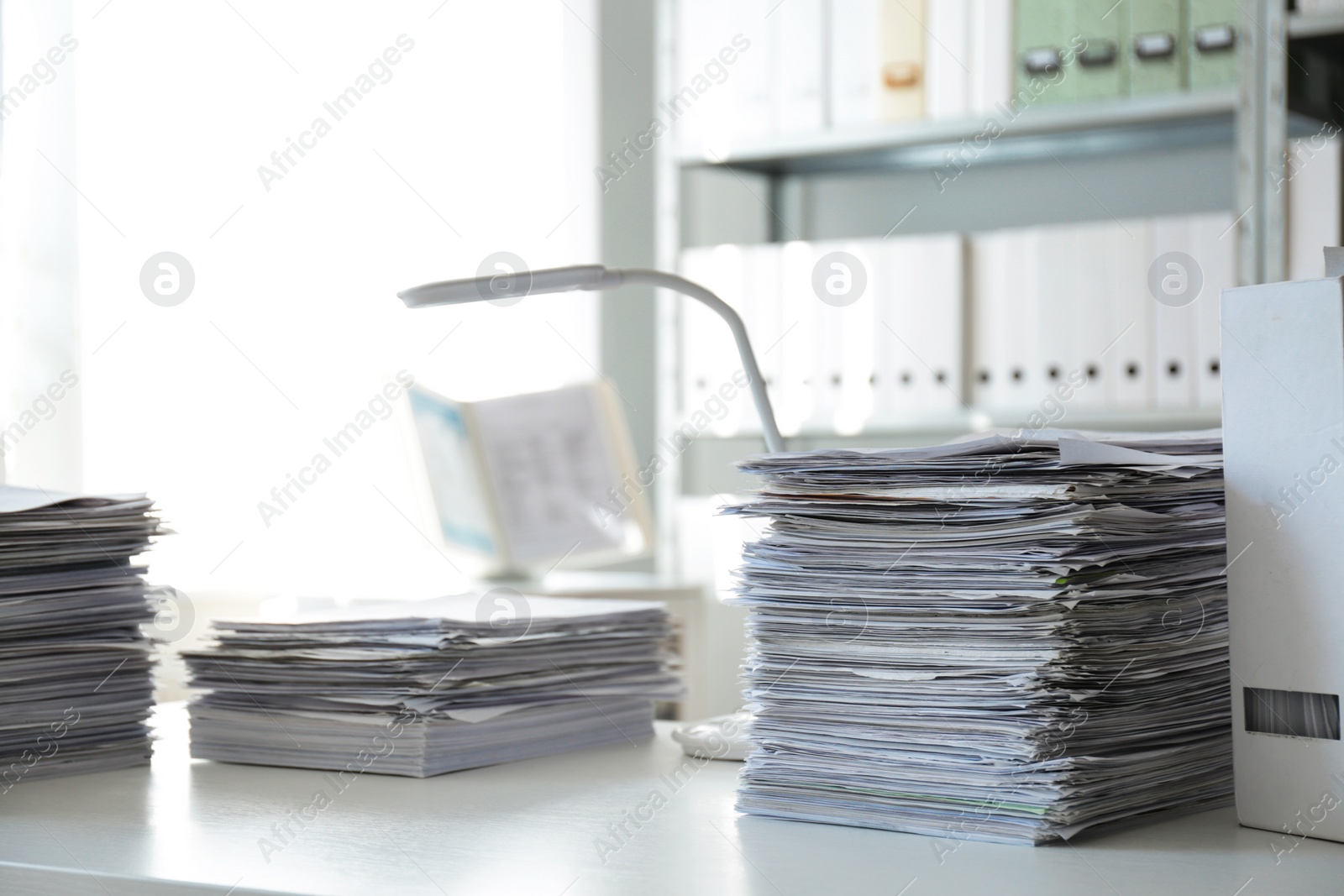 Photo of Stacks of documents on table in office