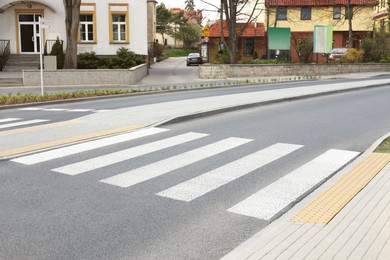 Photo of Asphalt road with pedestrian crossing on city street