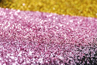 Photo of Gold and rose glitter as background, closeup