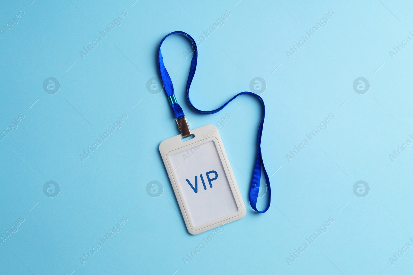 Photo of Plastic vip badge on light blue background, top view