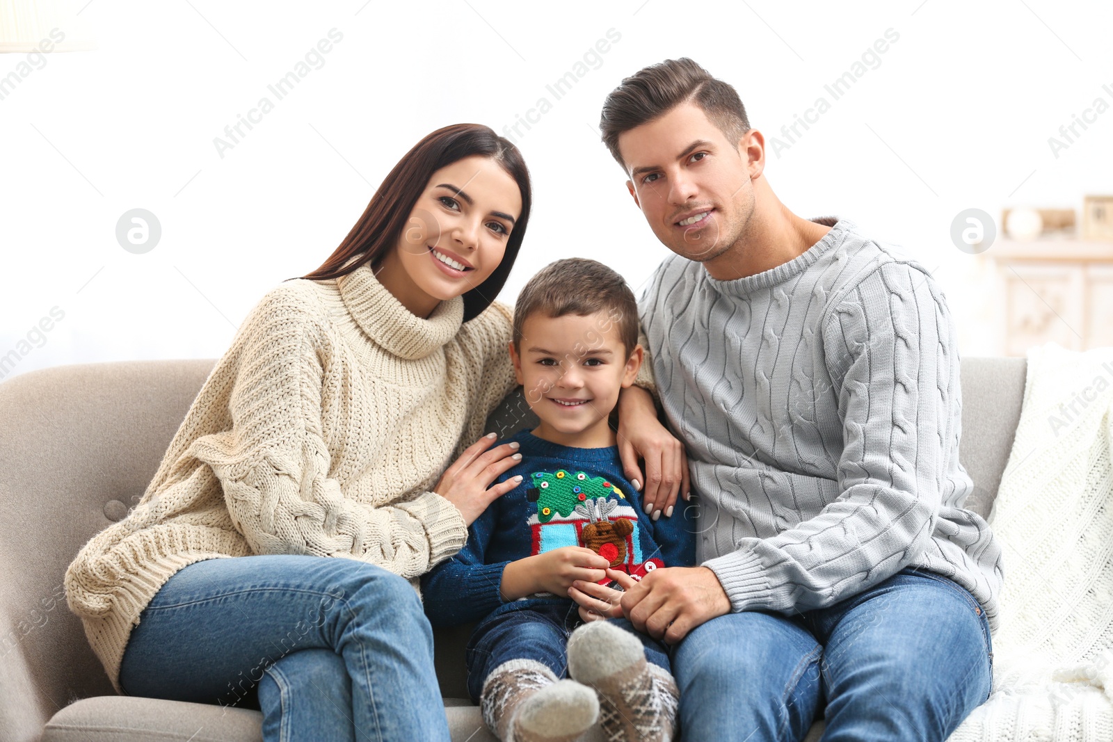 Photo of Happy family with little son spending time together at home. Winter vacation