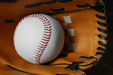 Professional leather baseball ball and glove, closeup