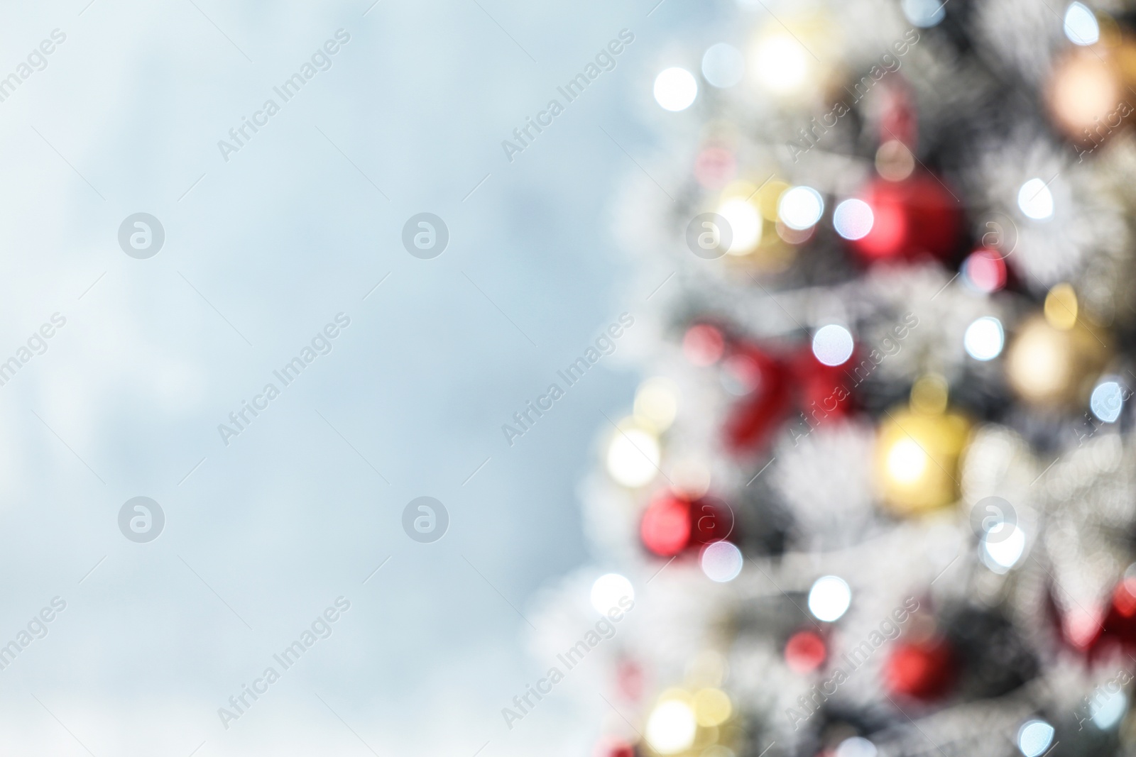 Photo of Beautiful Christmas tree with lights against grey background, blurred view. Space for text