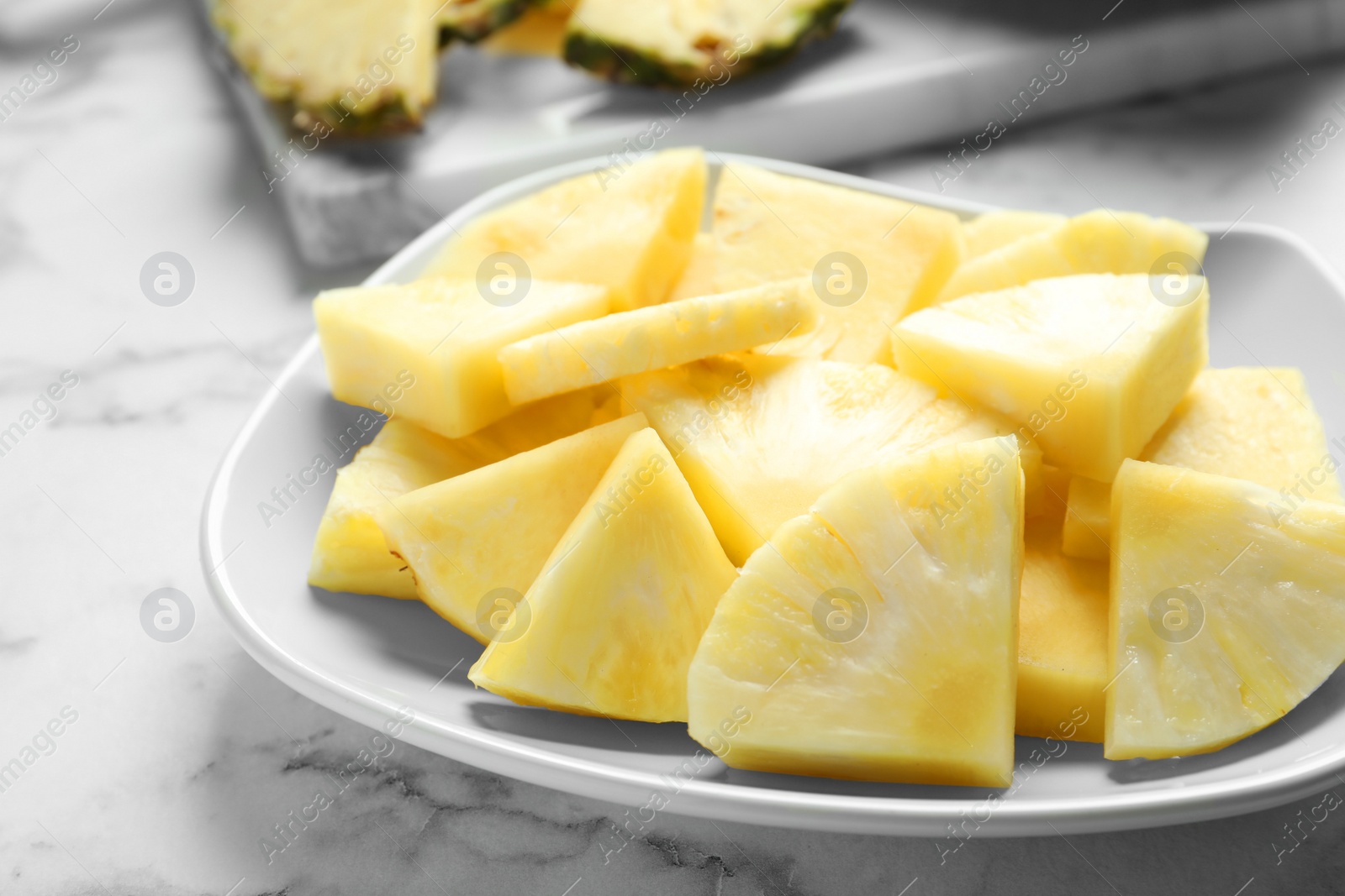 Photo of Plate with fresh sliced pineapple, closeup