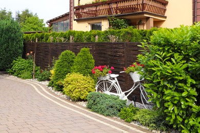 Cozy house surrounded by beautiful plants. Gardening and landscaping