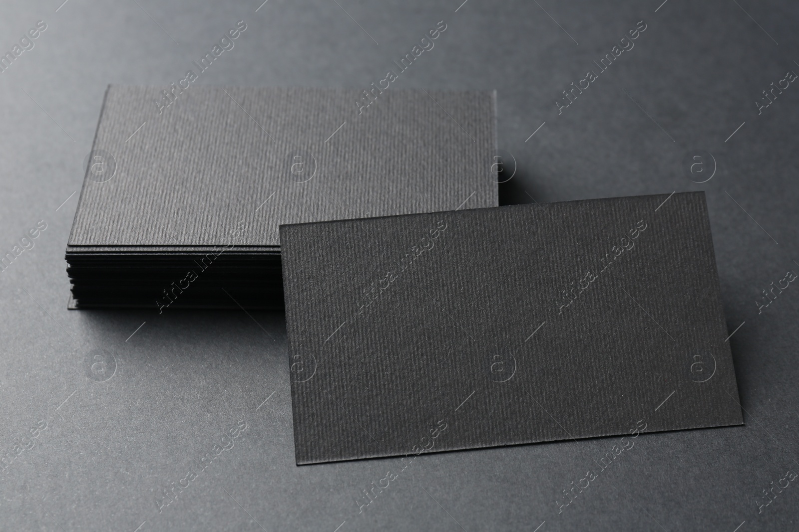 Photo of Blank business cards on black background, closeup. Mockup for design