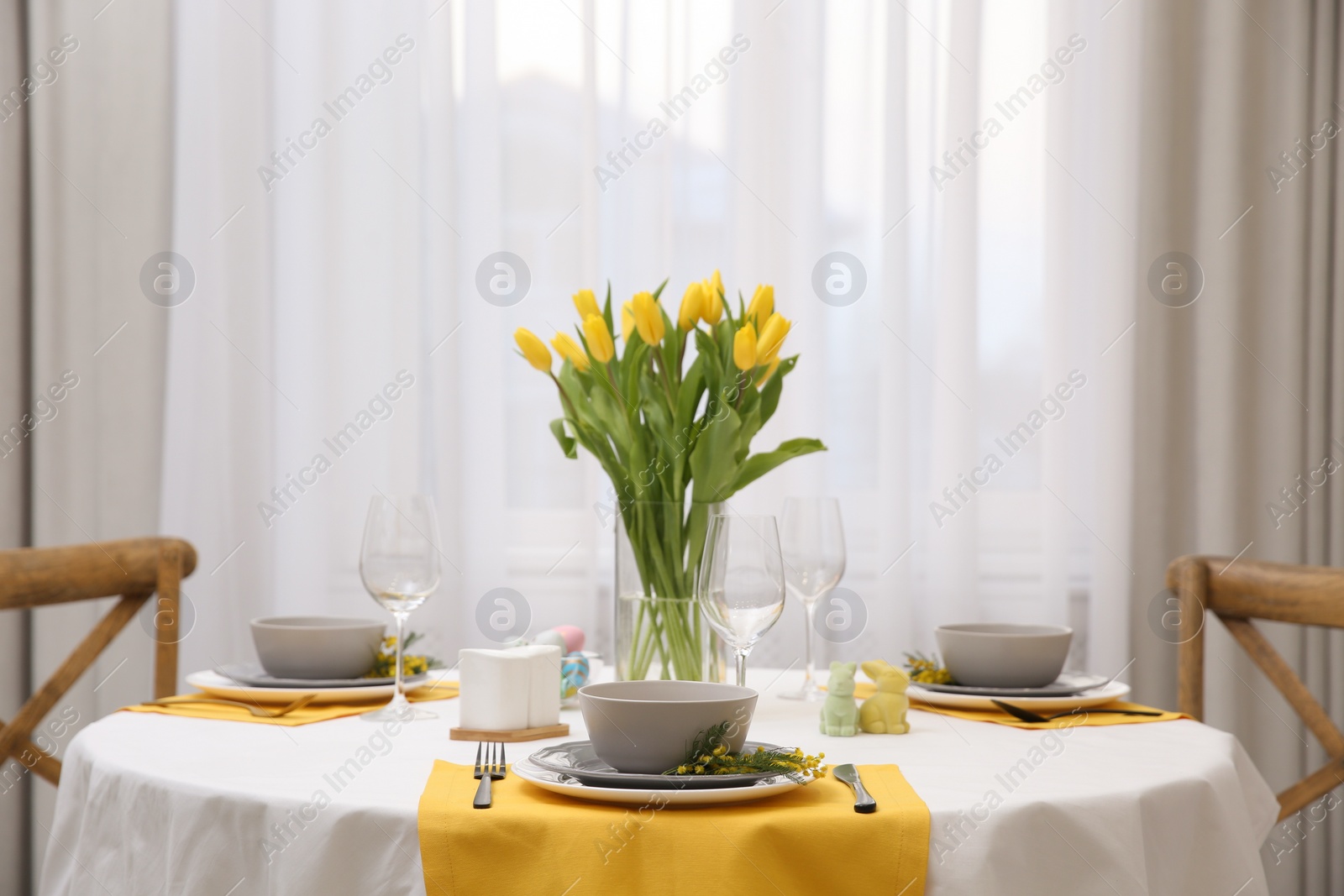 Photo of Beautiful Easter table setting with floral decor indoors