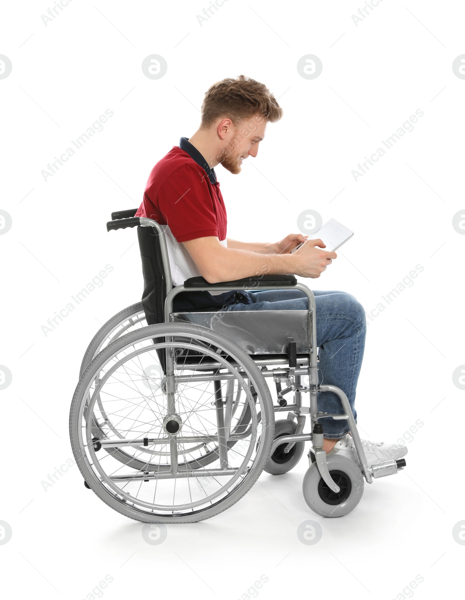 Photo of Young man in wheelchair using tablet isolated on white