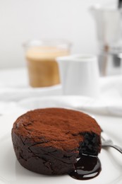 Photo of Delicious fresh fondant with hot chocolate served on white table, closeup