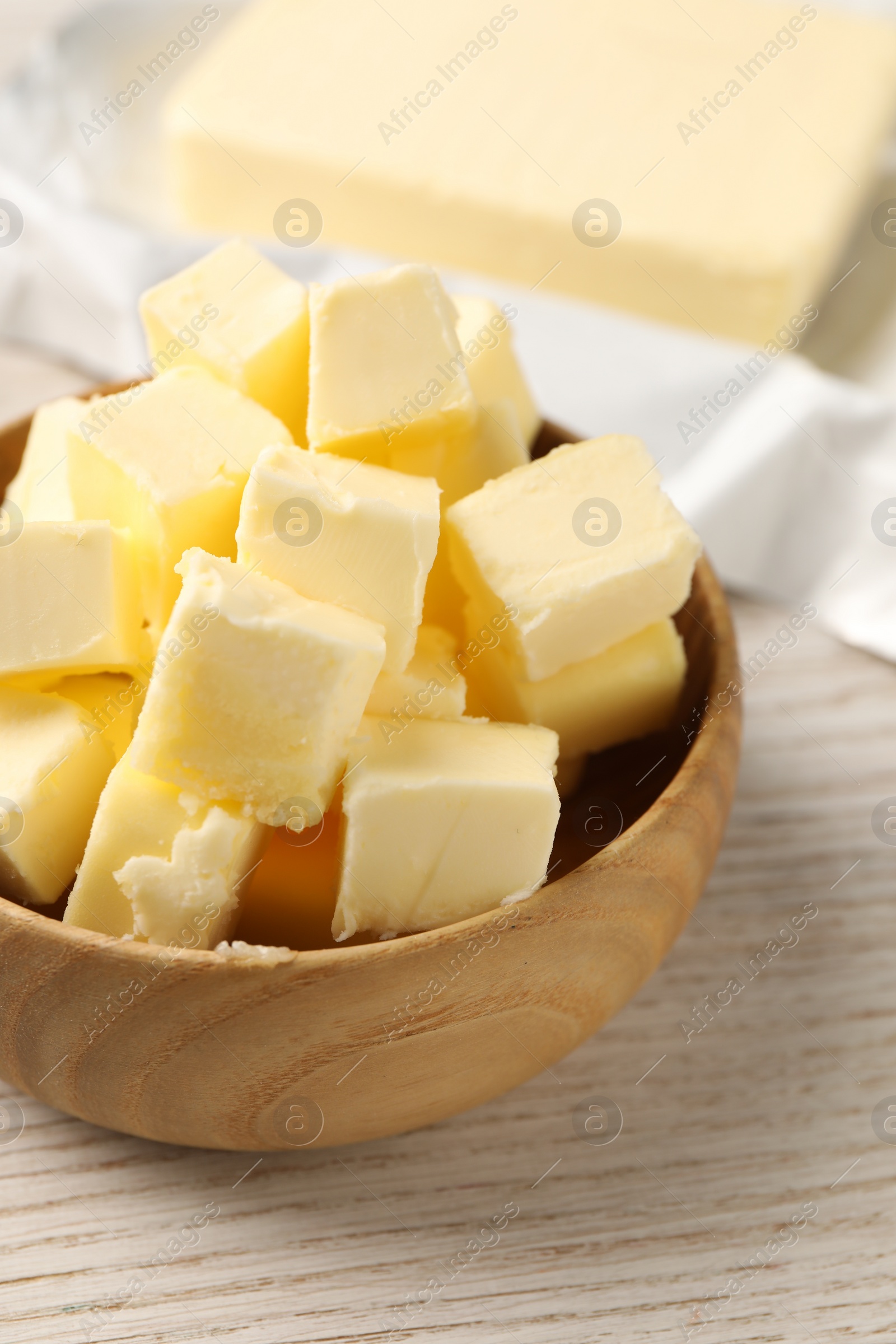 Photo of Tasty butter on light wooden table, closeup