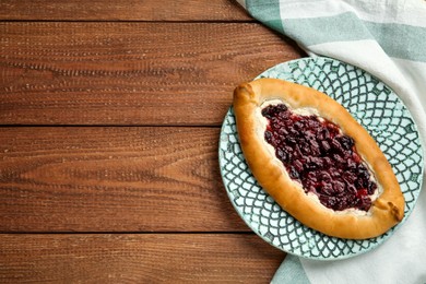 Photo of Delicious sweet cottage cheese pastry with cherry jam on wooden table, top view. Space for text