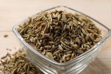 Photo of Fennel seeds in glass bowl on table, closeup