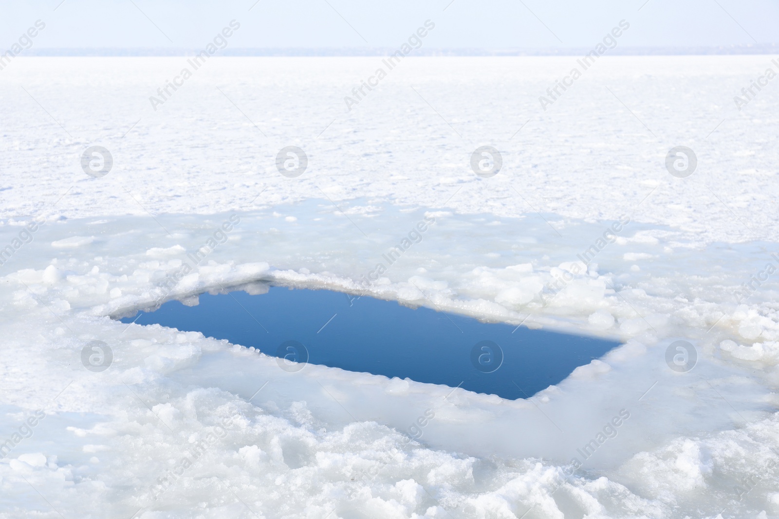 Photo of Ice hole in river on winter day. Baptism ritual