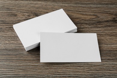 Blank business cards on wooden background. Mockup for design