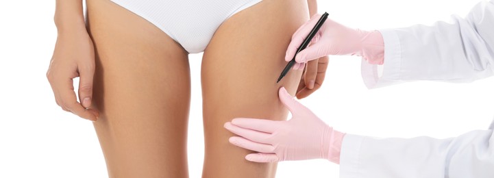 Plastic surgeon drawing marks on woman's body against white background, closeup. Banner design