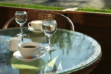 Photo of Cup of fresh aromatic coffee at table in cafe