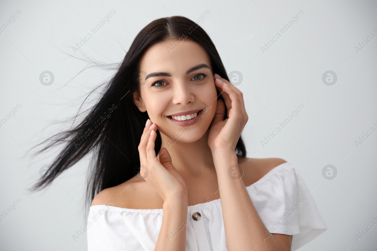 Photo of Beautiful young woman on light grey background