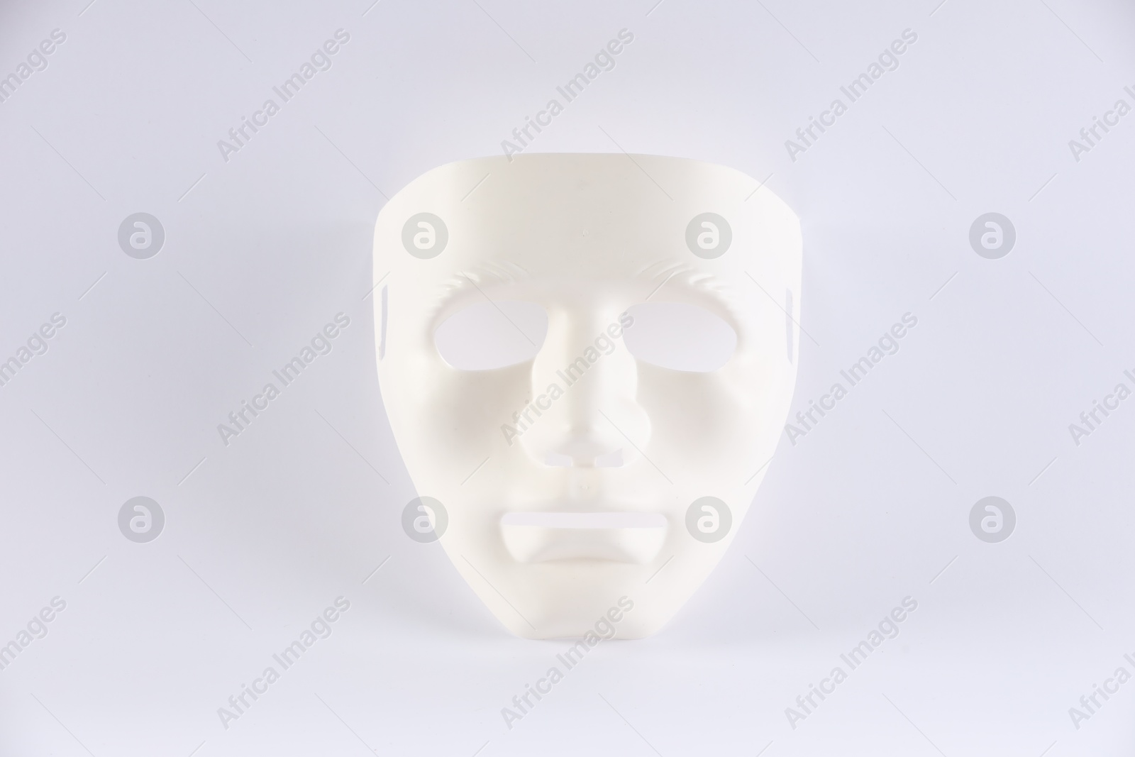 Photo of Plastic face mask on white background. Theatrical performance