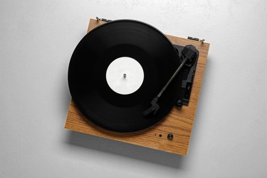 Photo of Turntable with vinyl record on white background, top view