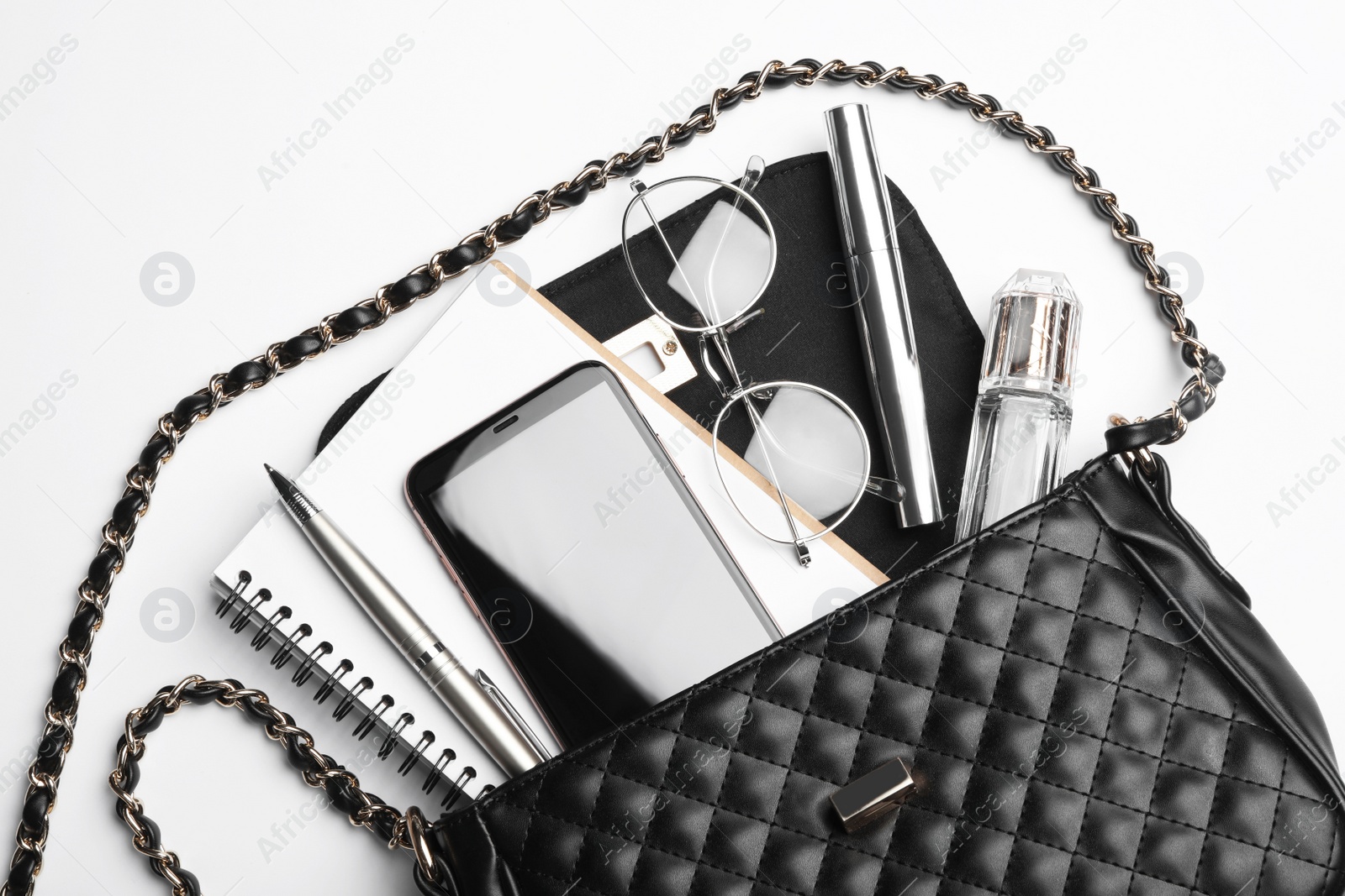 Photo of Stylish woman's bag with smartphone and accessories on white background, top view