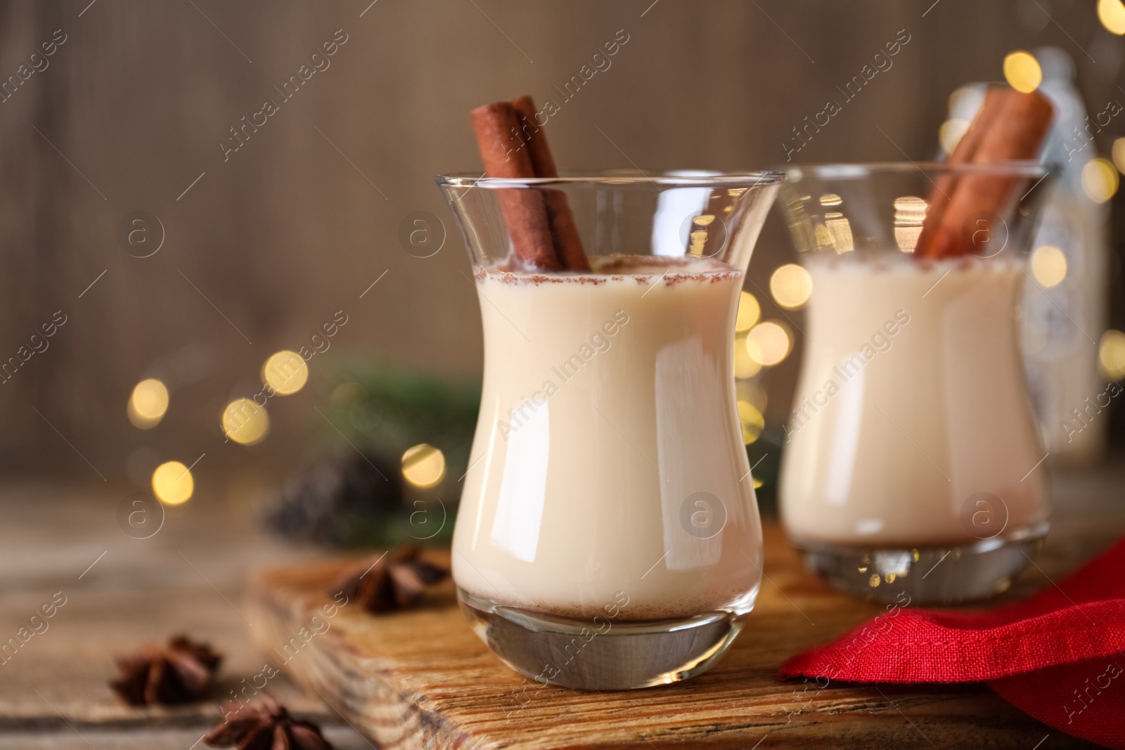 Photo of Delicious Christmas liqueur on wooden board, closeup