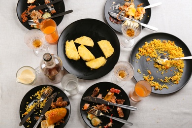 Photo of Composition with food leftovers after party on table, above view