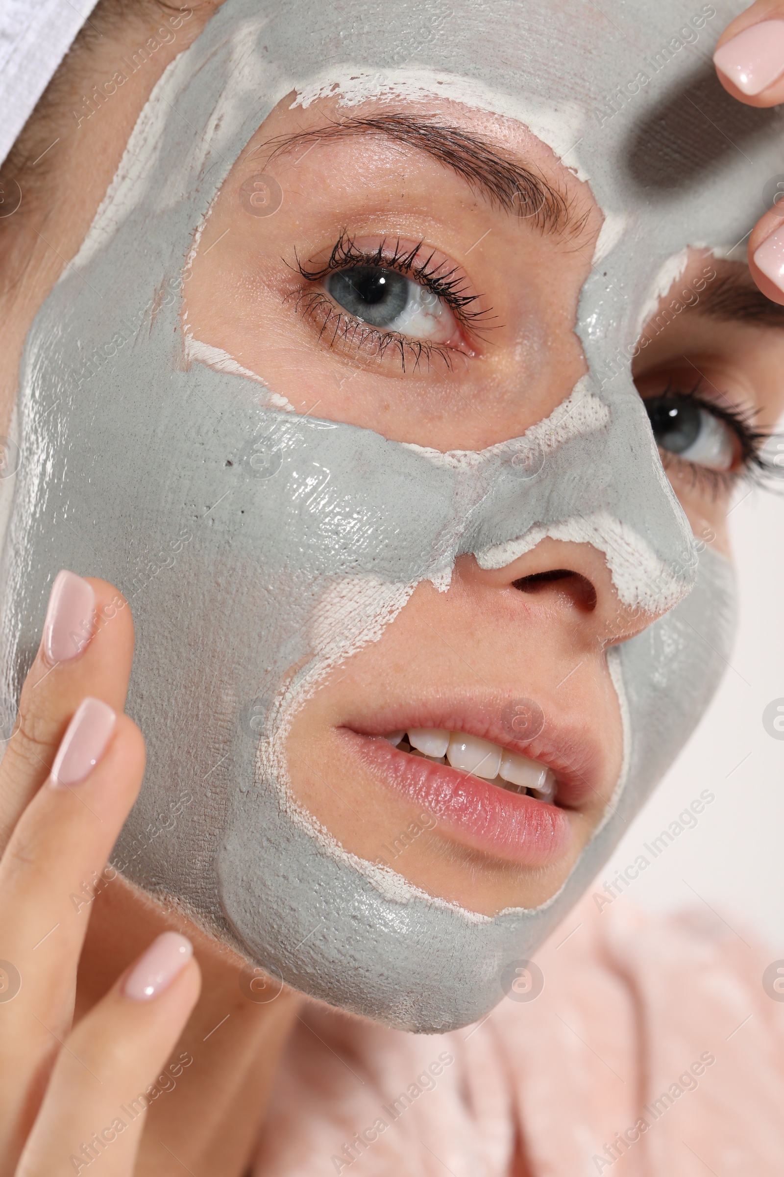 Photo of Woman with face mask on white background, closeup. Spa treatments