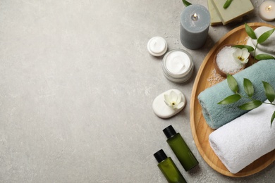 Photo of Flat lay spa composition with skin care products on grey textured table, space for text