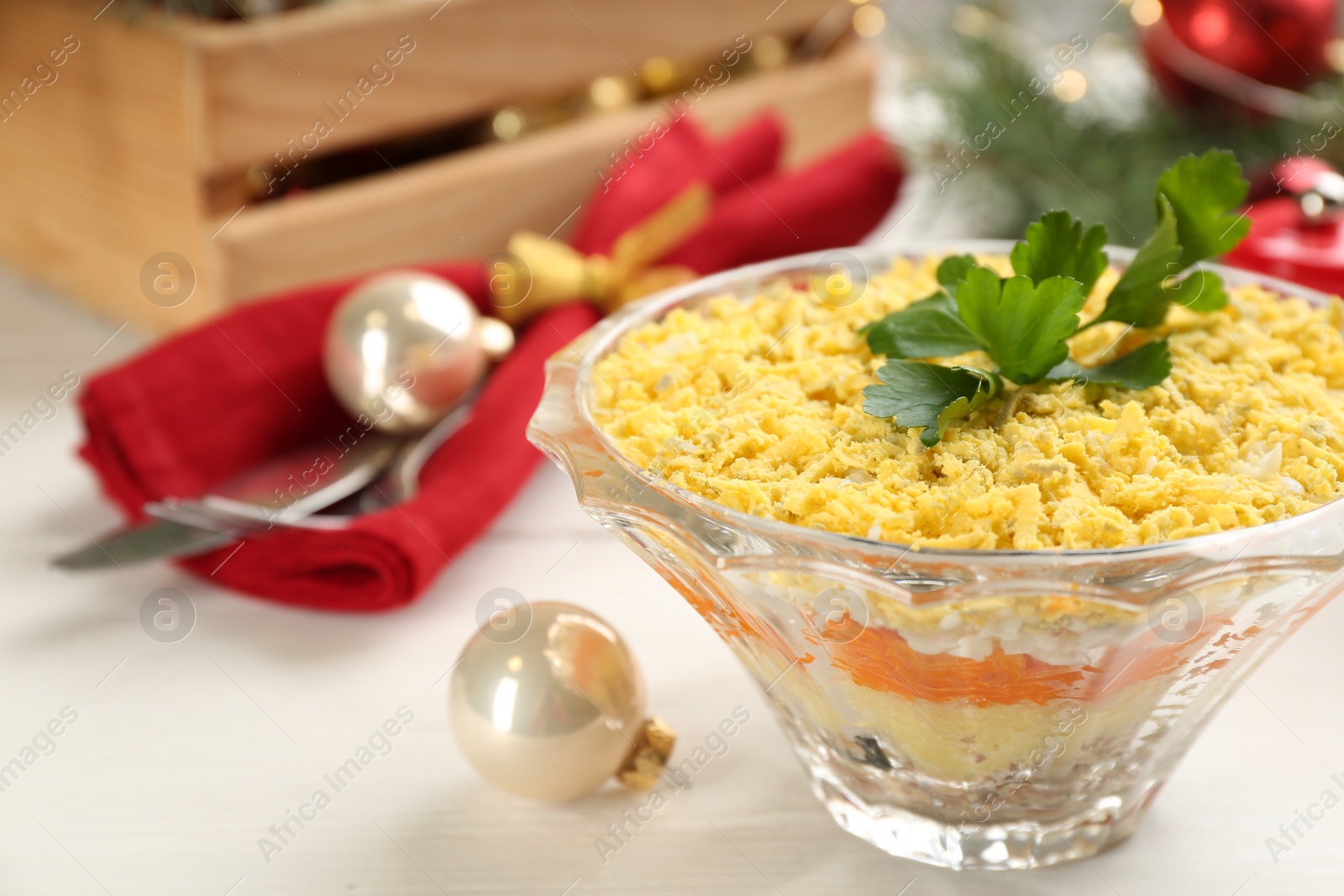 Photo of Traditional russian salad Mimosa served on white table, closeup. Space for text