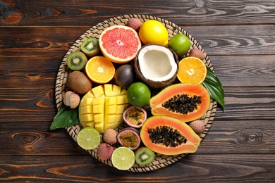 Fresh ripe papaya and other fruits on wooden table, top view