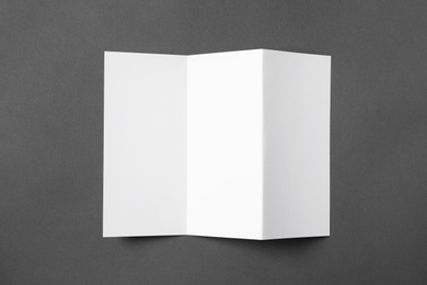 Photo of Blank brochure on gray background, view from above. Mock up for design
