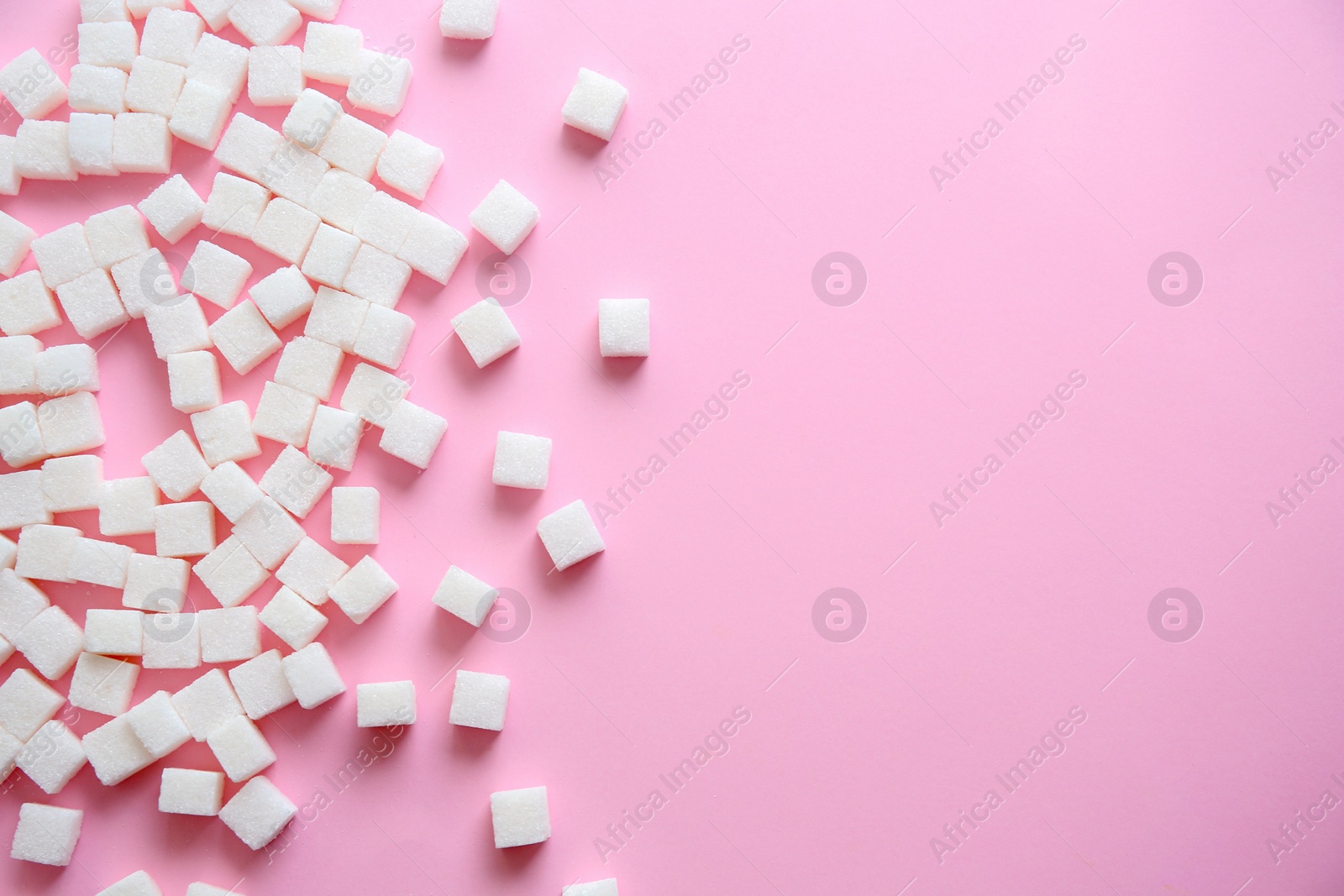 Photo of Refined sugar cubes on color background, top view