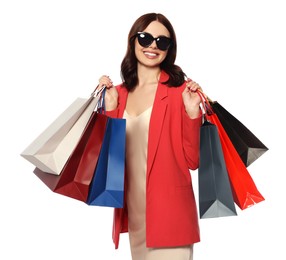 Beautiful young woman with paper shopping bags on white background