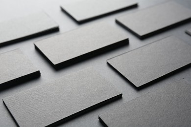 Blank business cards on black background, closeup. Mockup for design
