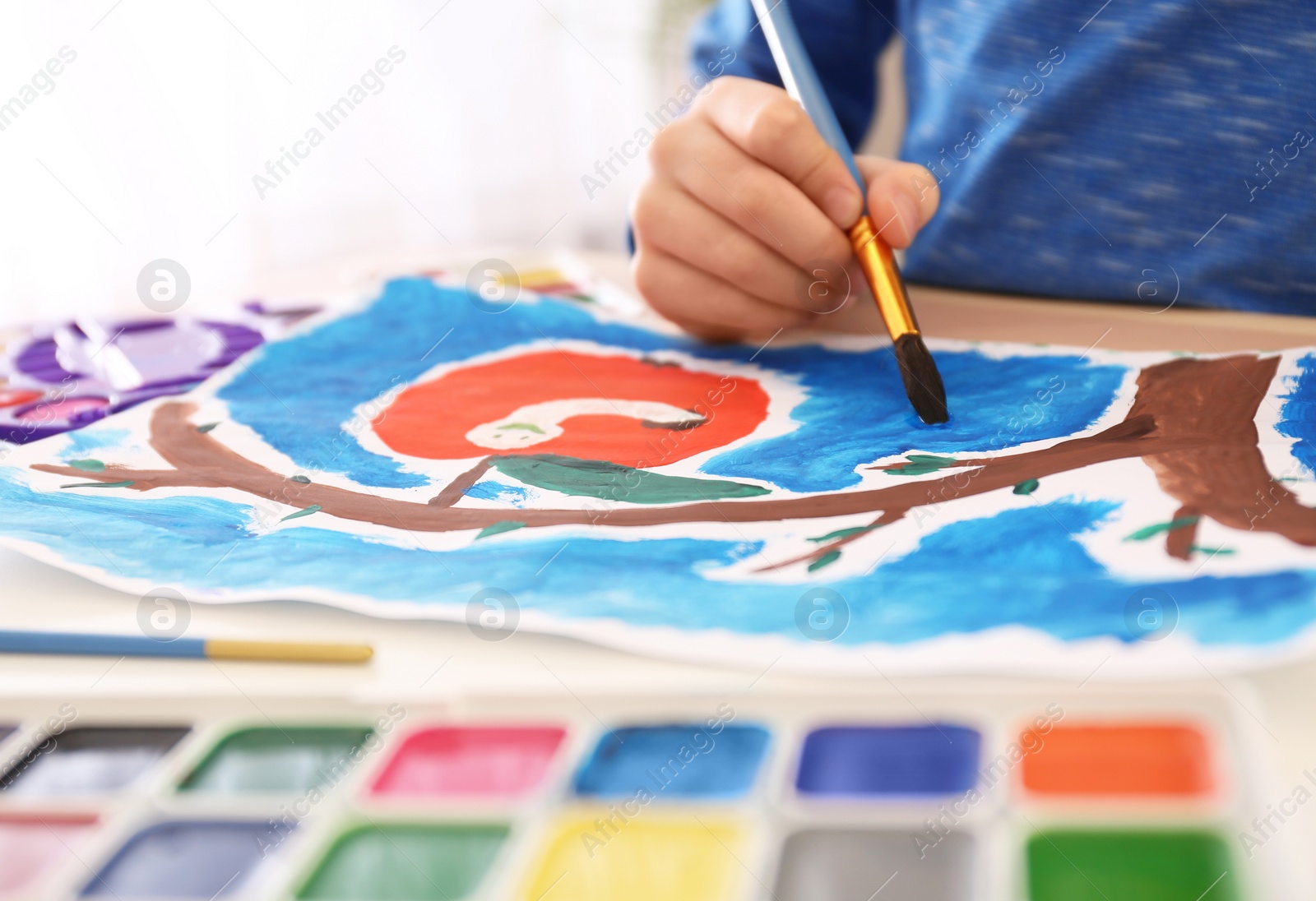 Photo of Little child painting at table, closeup view