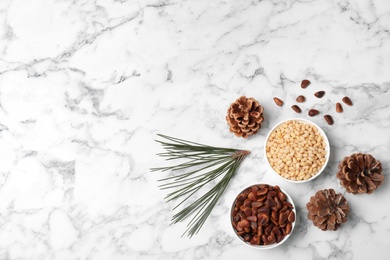 Flat lay composition with pine nuts on marble background. Space for text
