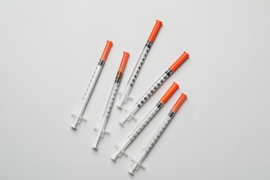 Photo of Disposable syringes on grey background, flat lay