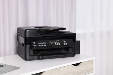 Photo of Modern printer with paper on white desk at home