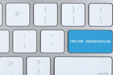Light blue button with text Online Reservation on keyboard, closeup view