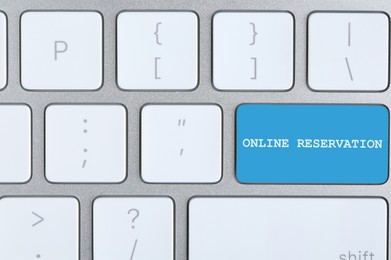 Image of Light blue button with text Online Reservation on keyboard, closeup view