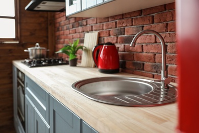 Photo of Stylish sink in modern kitchen. Home interior design