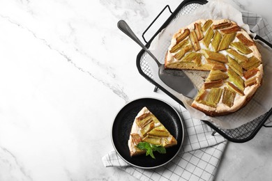 Photo of Freshly baked rhubarb pie and cake server on white marble table, flat lay. Space for text