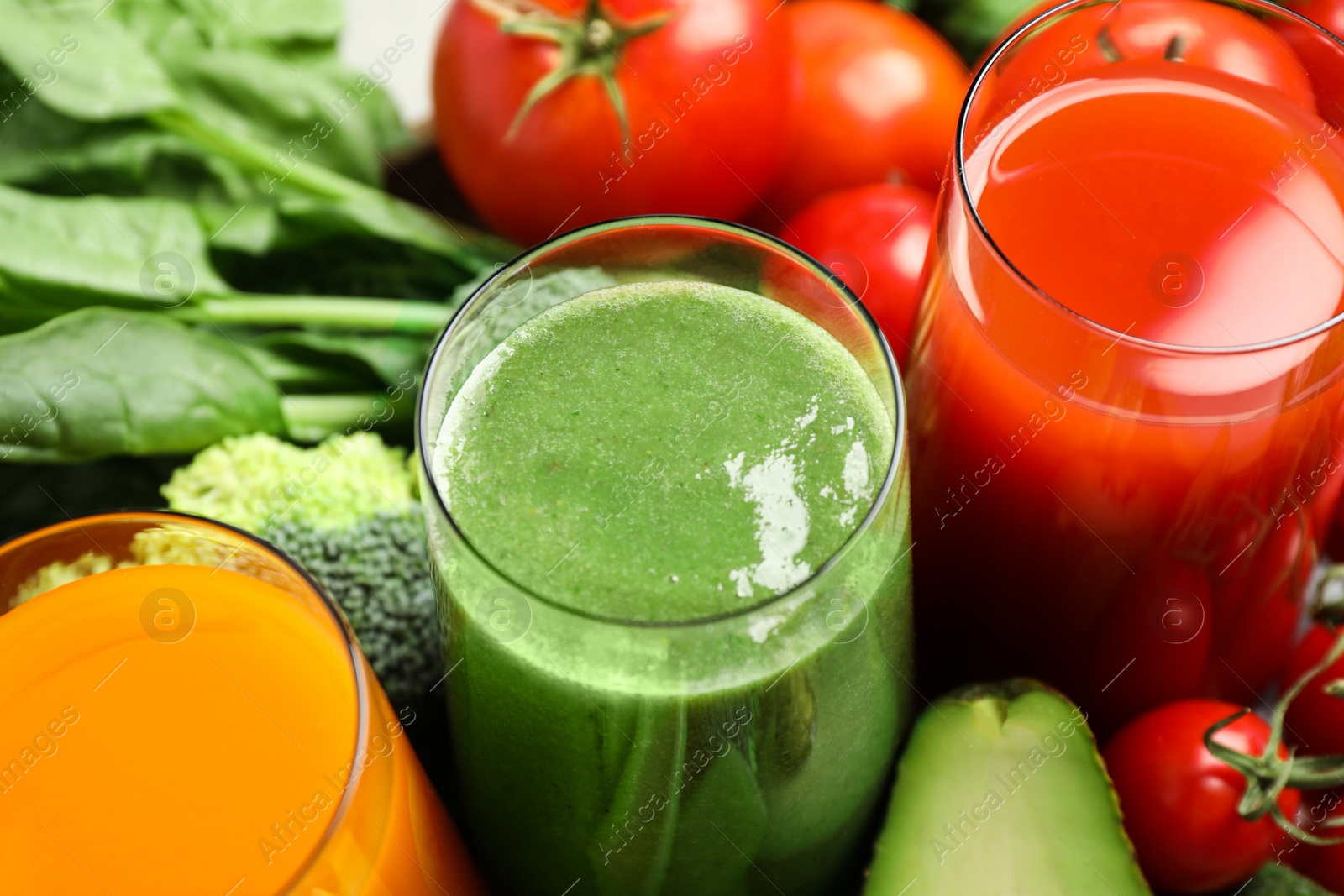 Photo of Delicious vegetable juices and fresh ingredients as background, closeup