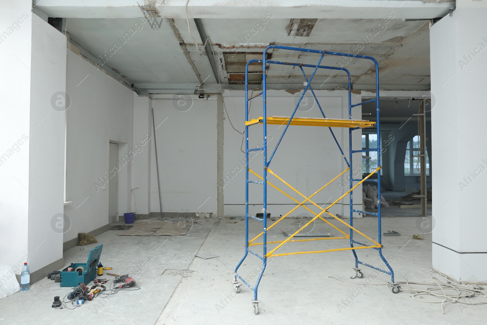 Photo of Scaffolds in messy room prepared for renovation