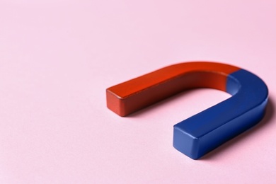 Photo of Red and blue horseshoe magnet on pink background