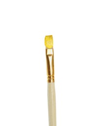 Photo of Brush with yellow paint on white background