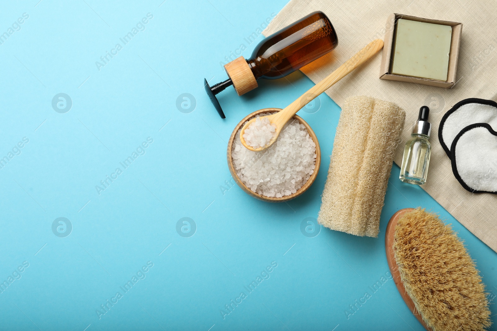 Photo of Flat lay composition with eco friendly products on light blue background, space for text