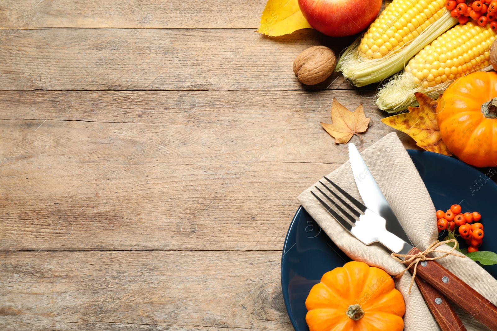 Photo of Flat lay composition with tableware, autumn fruits and vegetables on wooden background, space for text. Thanksgiving Day