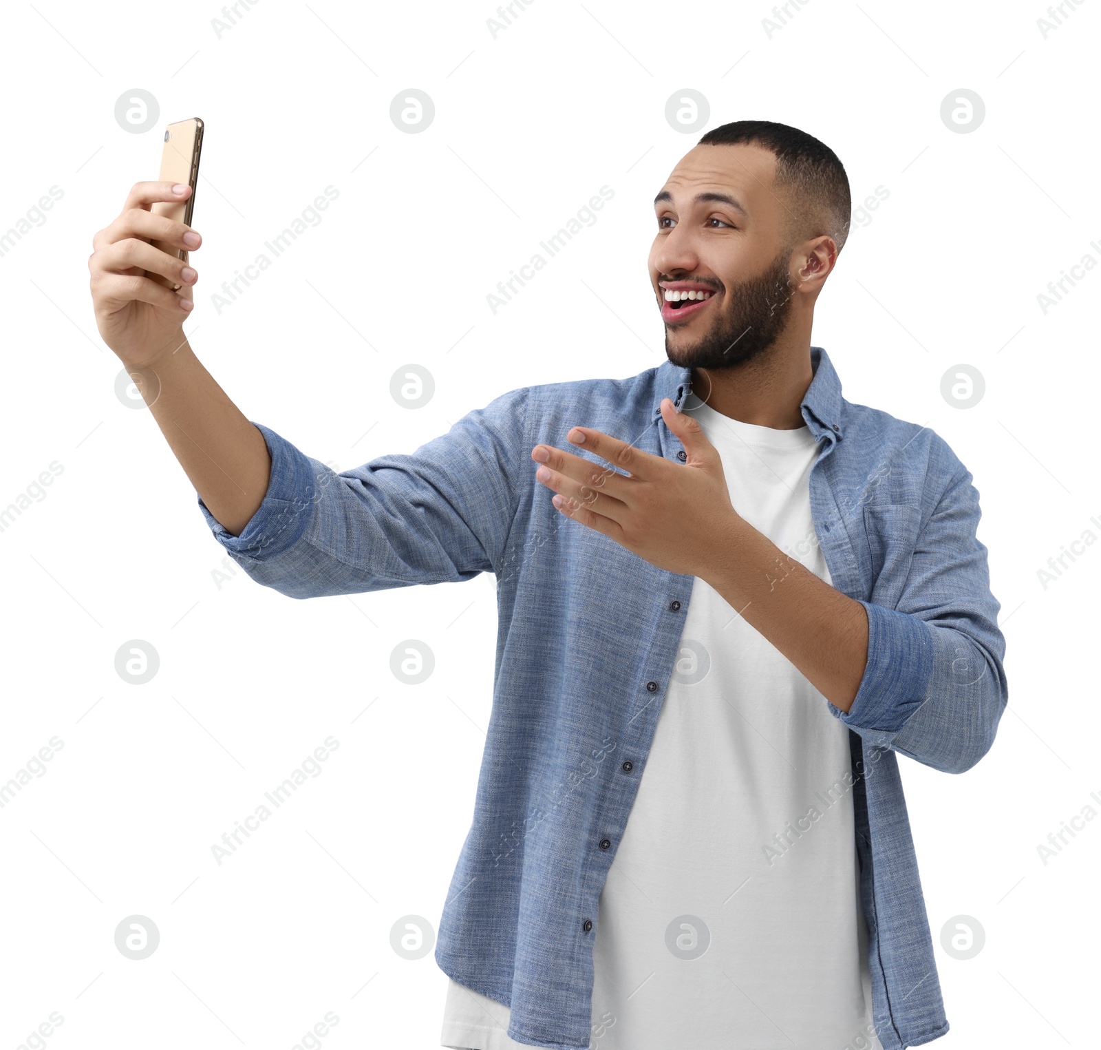 Photo of Smiling young man taking selfie with smartphone on white background